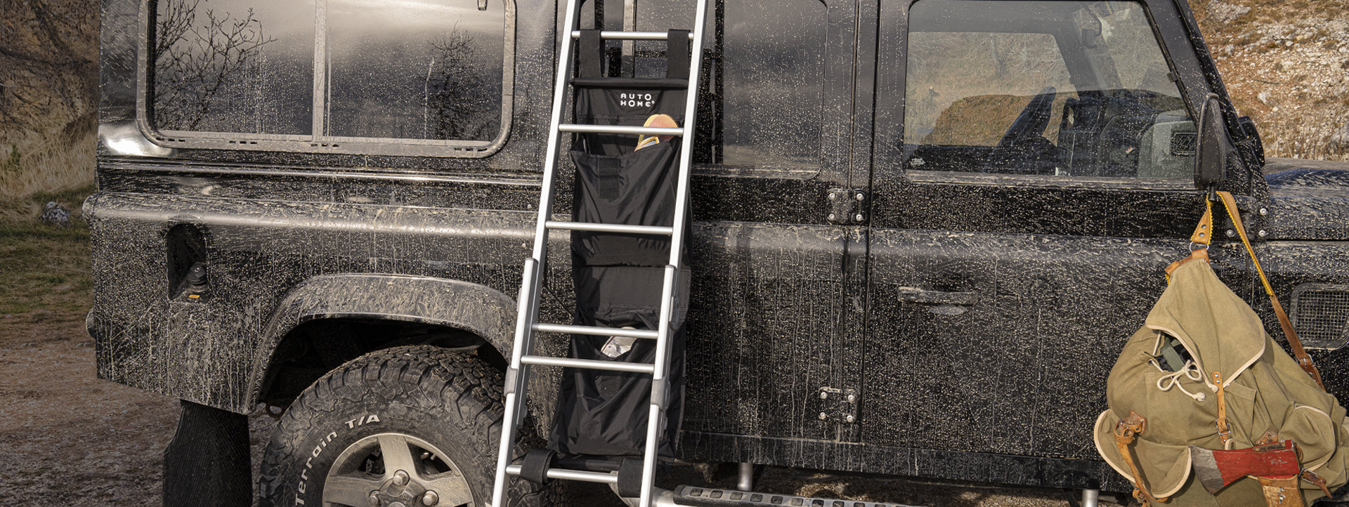 roll-up roof top tent shoe bag and pockets for autohome light weight hard shell roof top tent. would suit a james baroud, kings etc. made in italy. view on land rover defender on ladder