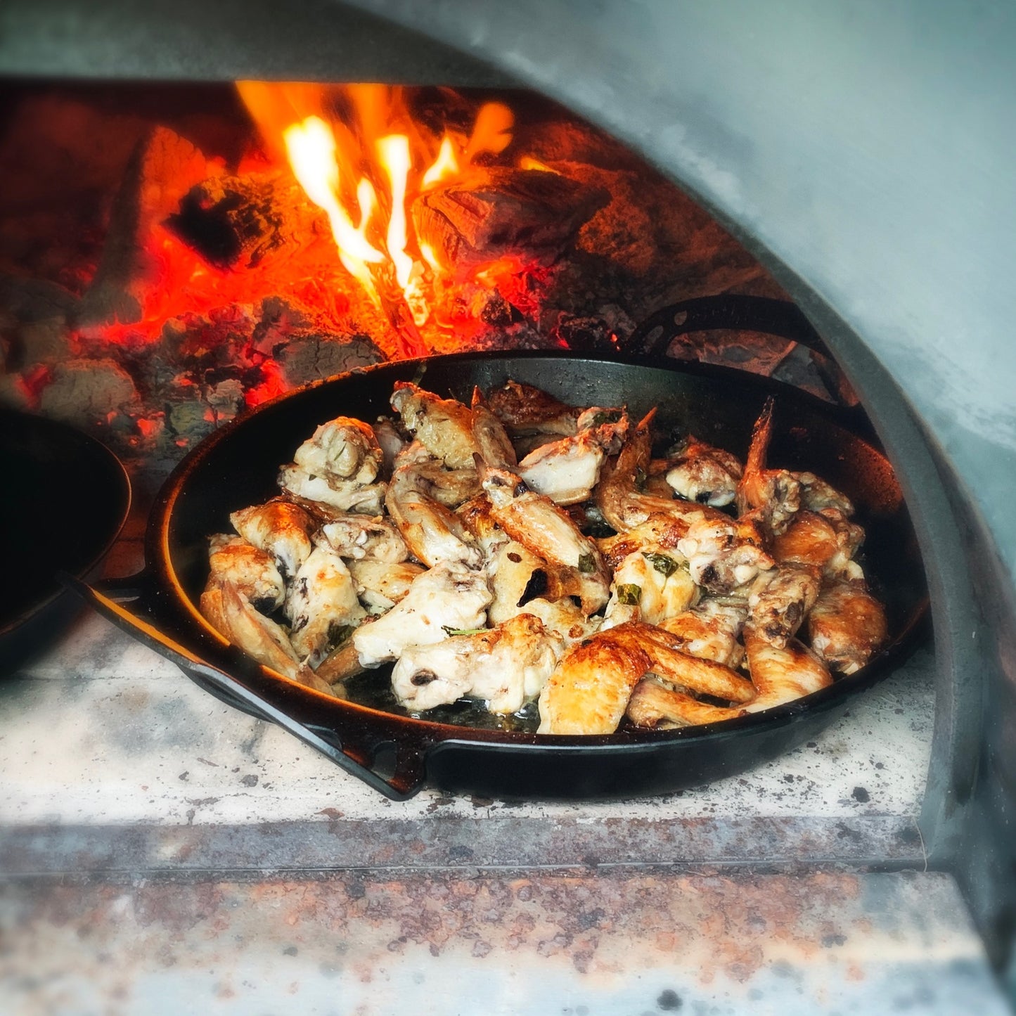 35cm Seasoned Iron BIGGA Skillet quenched for non-slip surface, durable nonstick pans, made in australia, great for camping over the fire cooking outdoors or at home. chicken pieces by solid teknics