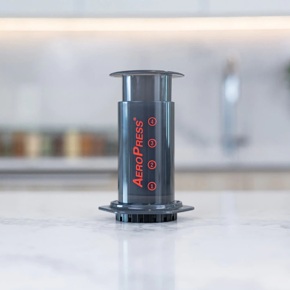 Aeropress coffee maker, front view in kitchen. A camp coffee equipment main stay, for coffee on the go. Use fresh ground coffee for best results. Enjoy coffee at camp, next to the fire.