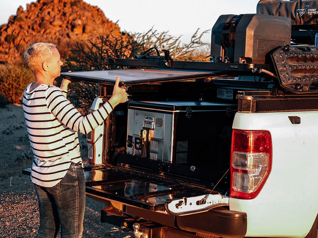 in use shot of front runner pro camp and prep table kit australia melbourne stainless camp table, the best and sturdiest and strongest, store under a roof rack slide it out the way